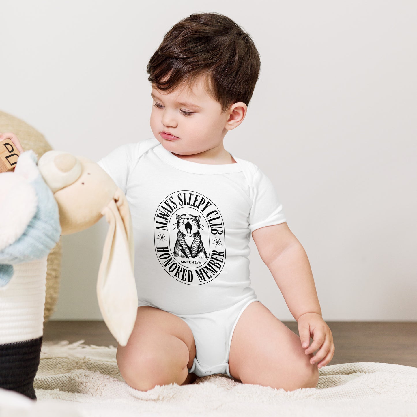 baby onesie with 'Always Sleepy Club Honored Member' yawning cat design