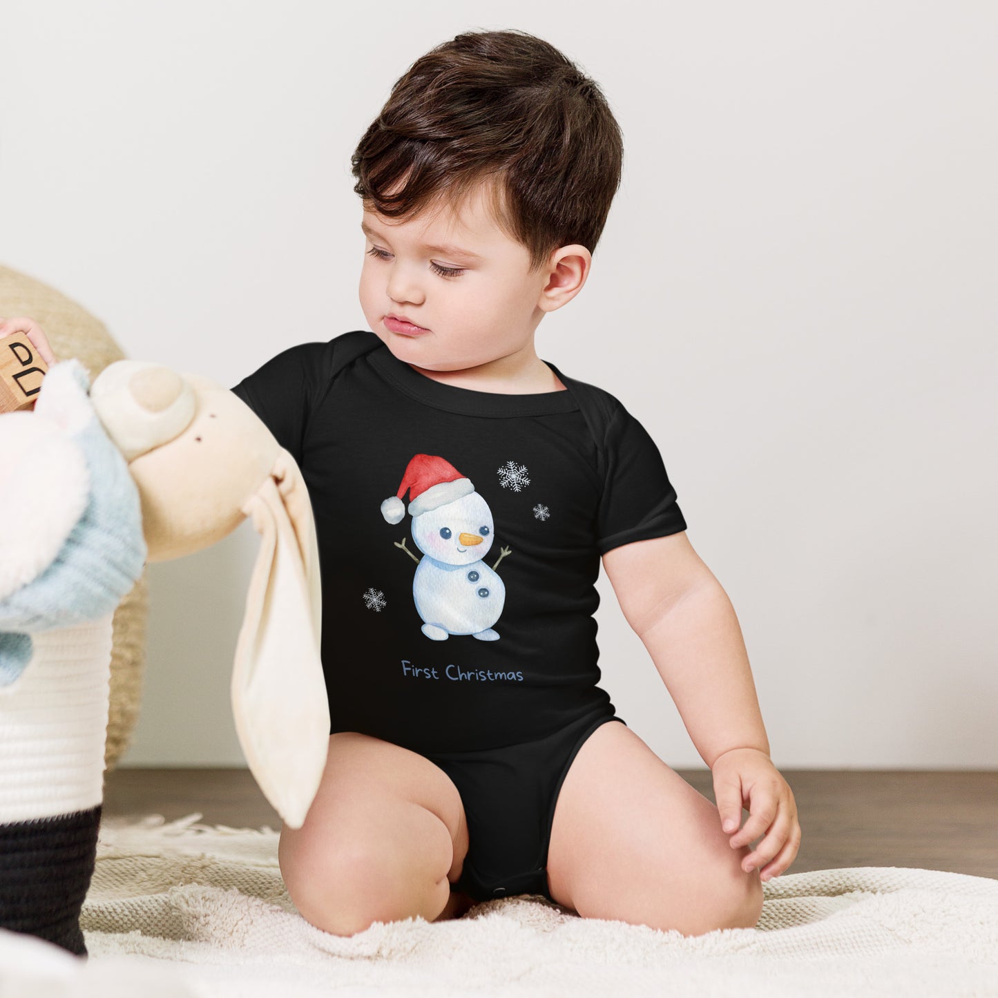 baby onesie with 'first christmas' text and cute santa snowman graphic