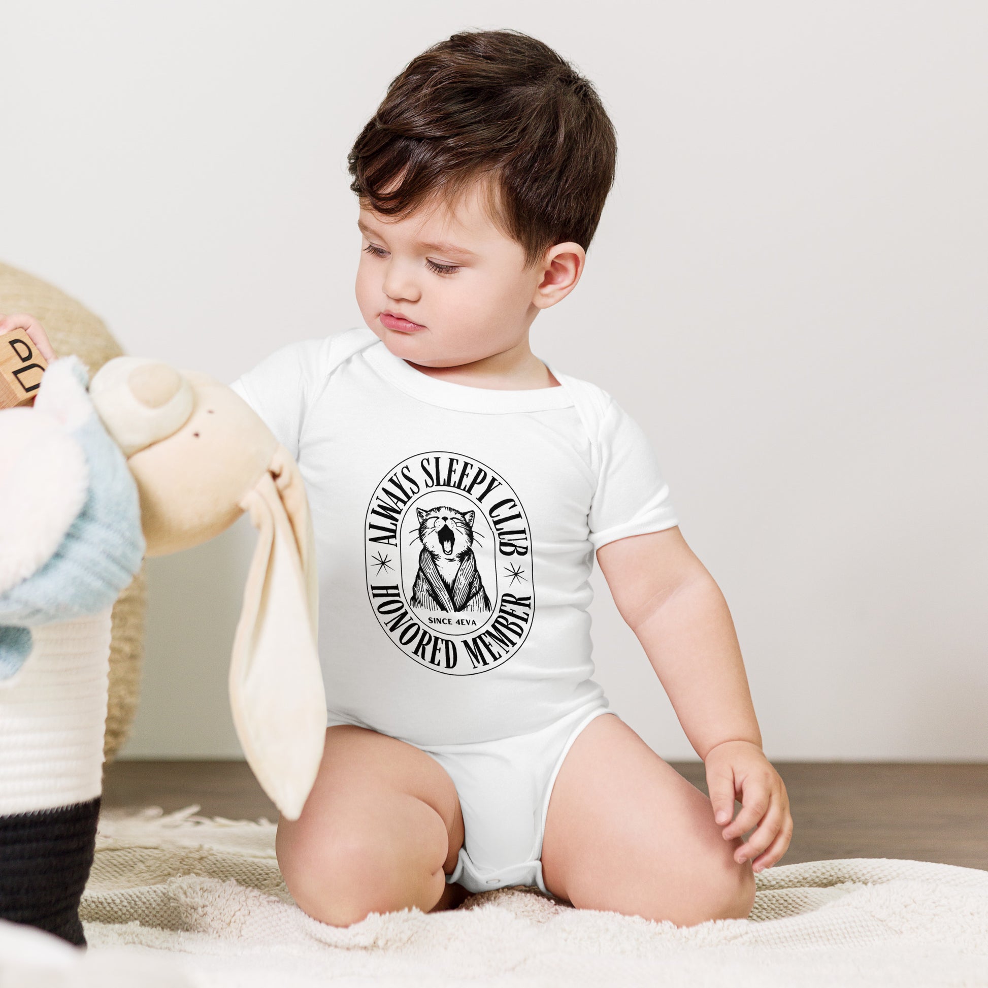 baby onesie with 'Always Sleepy Club Honored Member' yawning cat design