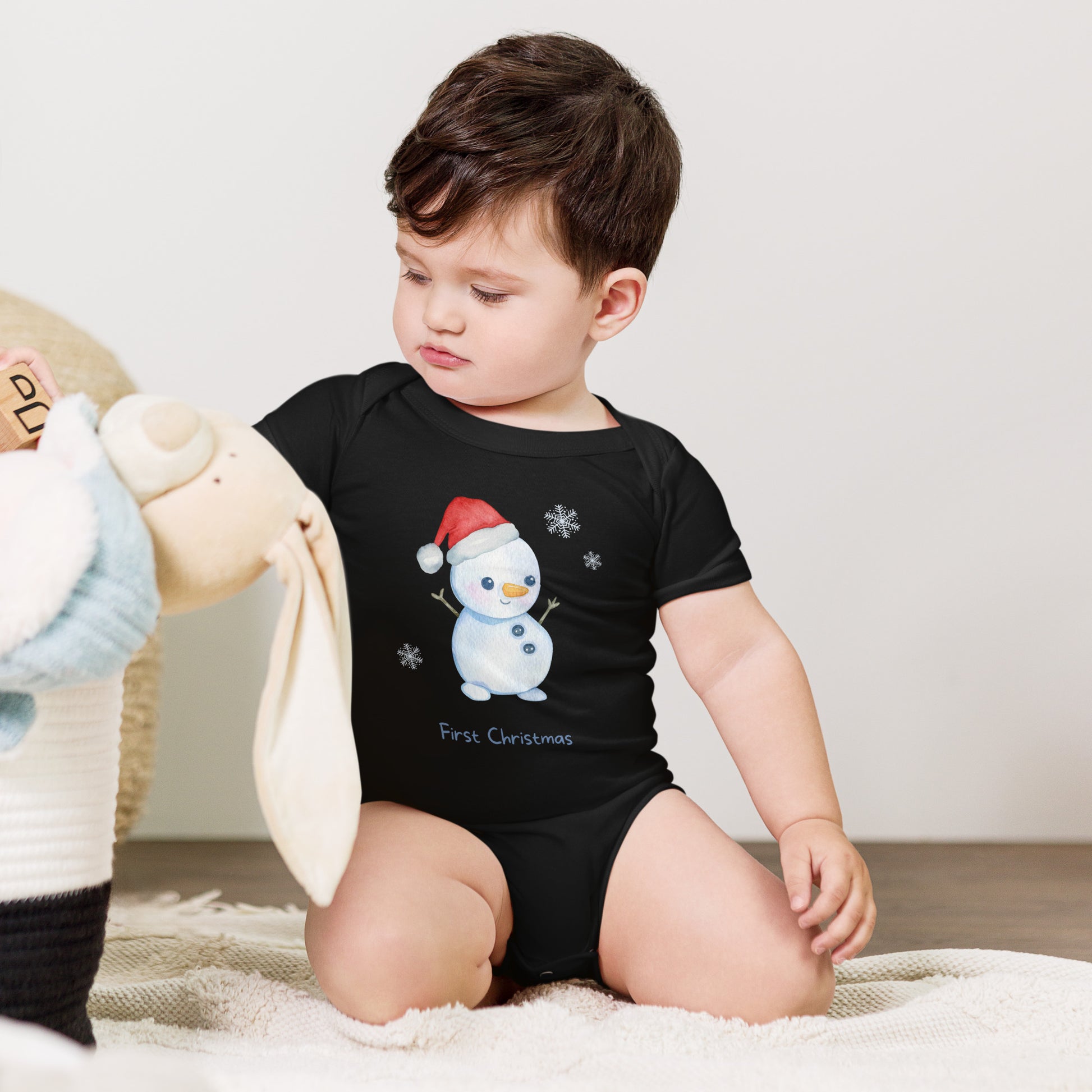 baby onesie with 'first christmas' text and cute santa snowman graphic