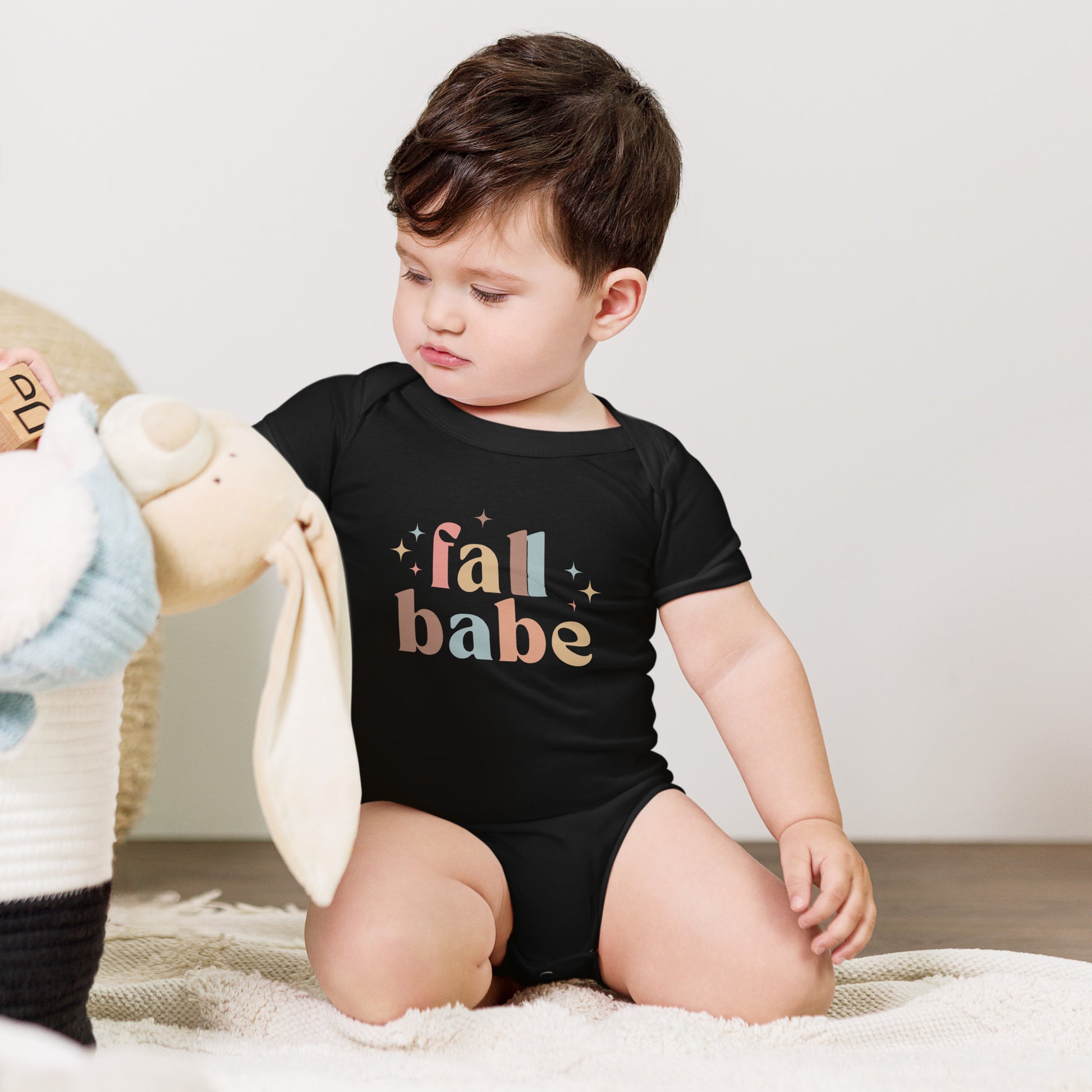 baby onesie with 'fall babe' text design in autumn colors