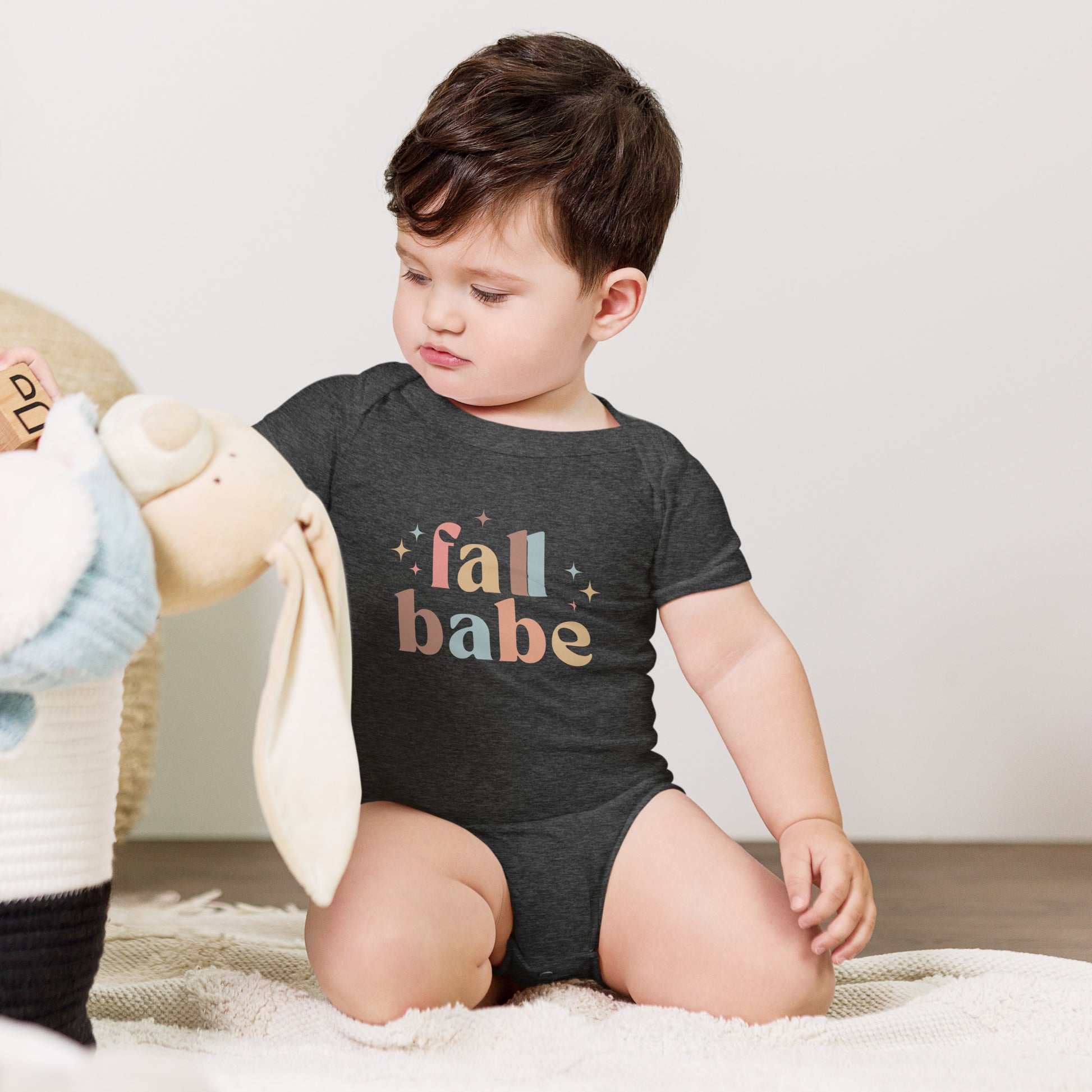 baby onesie with 'fall babe' text design in autumn colors