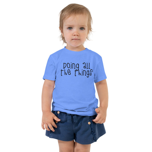 toddler t-shirt with 'Doing All the Things' text in child-like handwritten style